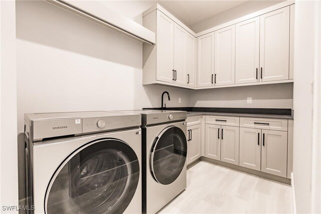 washroom with cabinets and separate washer and dryer