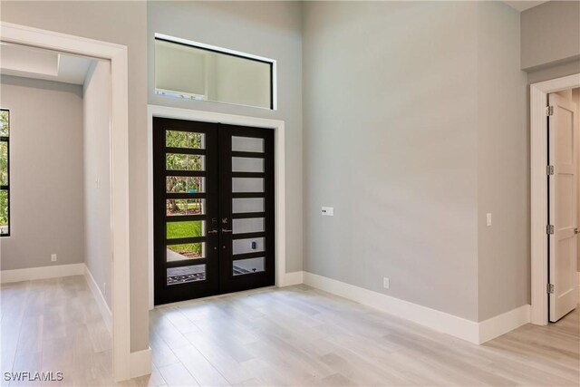 foyer entrance featuring light wood-type flooring and french doors