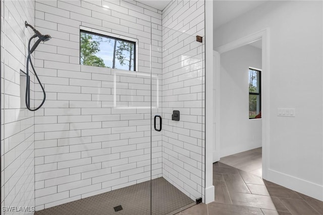 bathroom with plenty of natural light and a shower with shower door