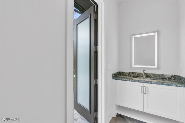 bathroom with tile patterned flooring and vanity