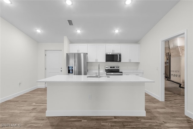 kitchen with a center island with sink, white cabinets, sink, and appliances with stainless steel finishes