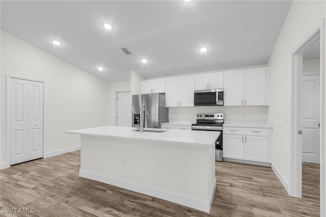 kitchen with a center island with sink, sink, white cabinets, and stainless steel appliances