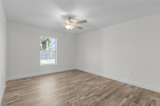 empty room with ceiling fan and light hardwood / wood-style floors