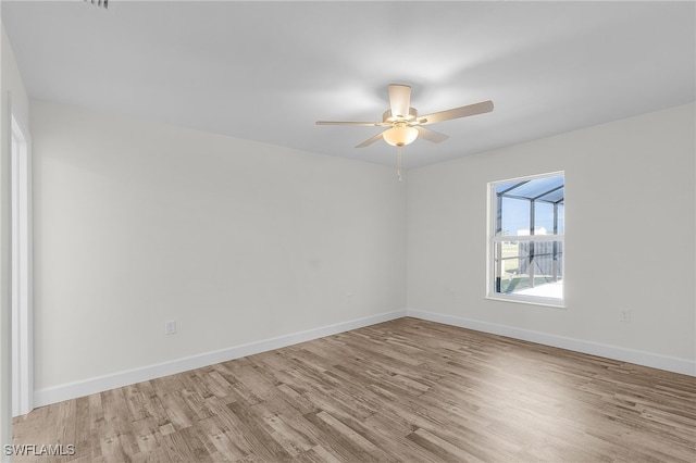 unfurnished room with ceiling fan and light wood-type flooring