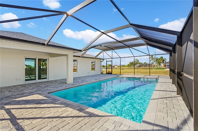 view of swimming pool featuring a lanai and a patio area