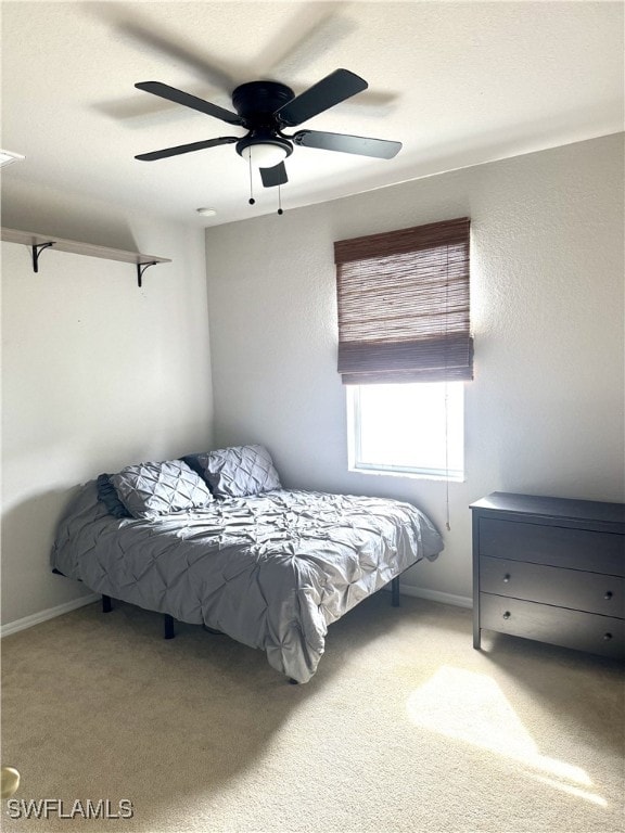 carpeted bedroom with ceiling fan