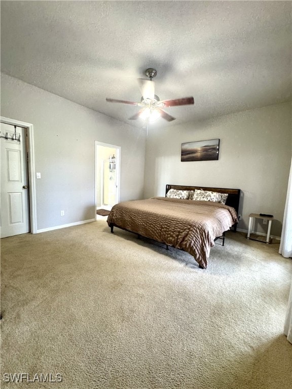 carpeted bedroom featuring a textured ceiling and ceiling fan