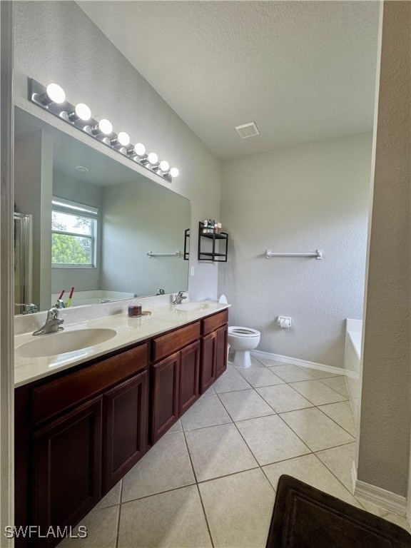 full bathroom featuring a textured ceiling, vanity, tile patterned flooring, shower with separate bathtub, and toilet