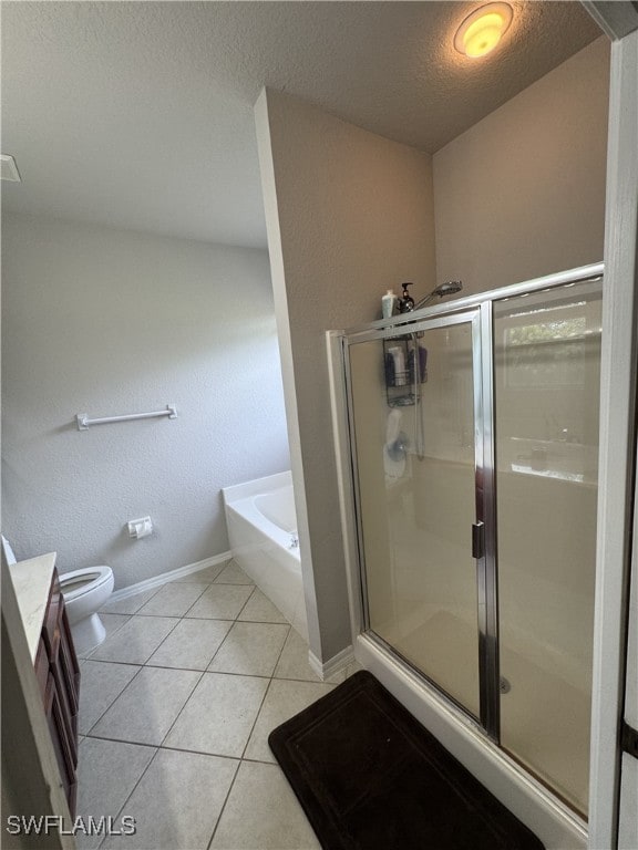 full bathroom featuring vanity, tile patterned flooring, toilet, a textured ceiling, and independent shower and bath