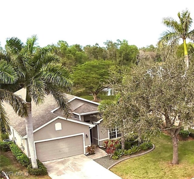 view of front of property with a front lawn and a garage