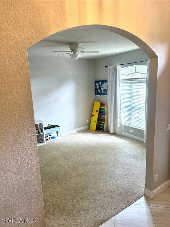 empty room featuring carpet and ceiling fan