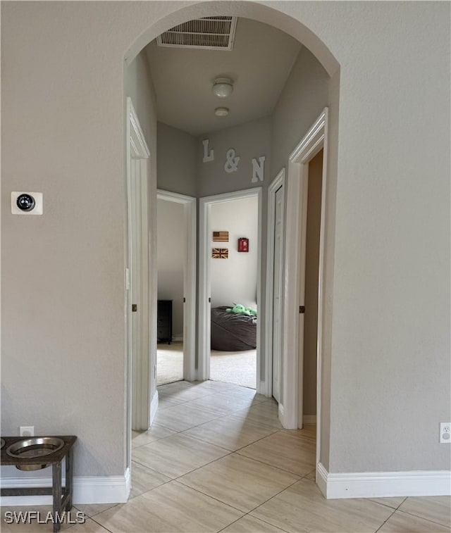 corridor with light tile patterned floors