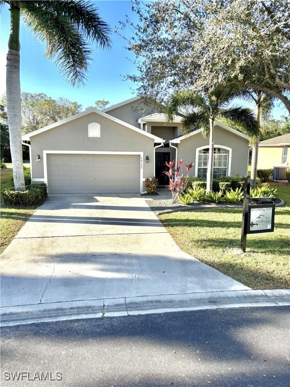 view of front of property featuring a front yard and a garage