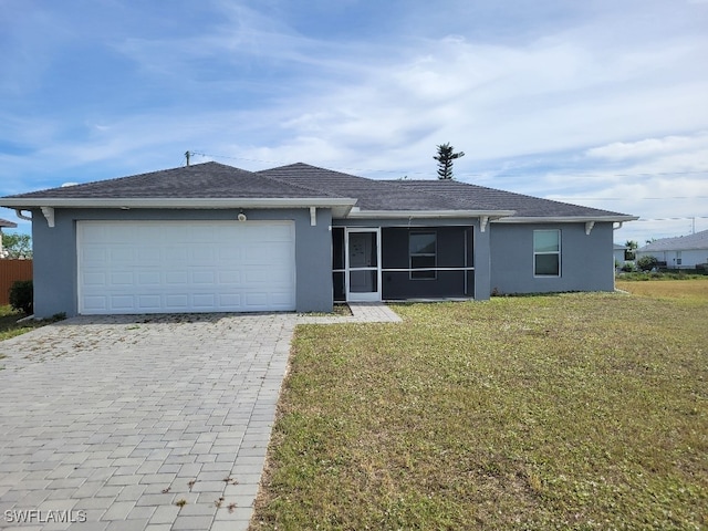 single story home with a sunroom, a garage, and a front yard