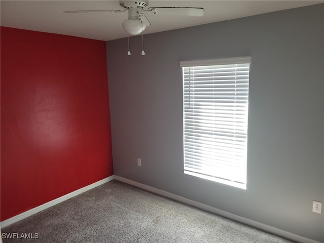 carpeted empty room featuring ceiling fan