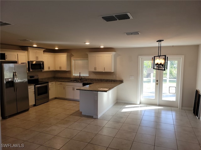 kitchen with appliances with stainless steel finishes, french doors, sink, light tile patterned floors, and white cabinets