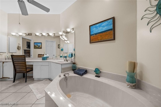 bathroom with tiled bath, ceiling fan, tile patterned flooring, and vanity