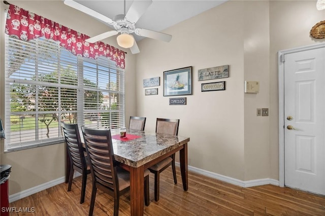 dining area with hardwood / wood-style floors and ceiling fan