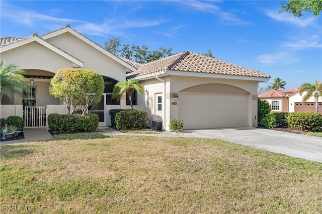 mediterranean / spanish house featuring a front yard, a garage, and covered porch