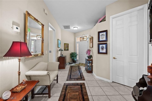 hall featuring light tile patterned floors