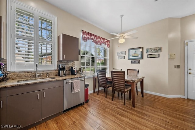 kitchen with sink, light hardwood / wood-style flooring, stainless steel dishwasher, ceiling fan, and dark brown cabinets