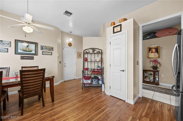 dining room with hardwood / wood-style flooring and ceiling fan