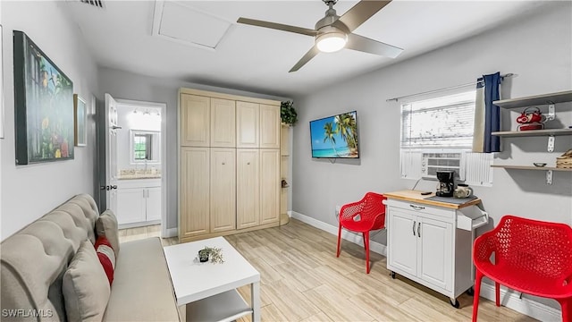 office area with light hardwood / wood-style flooring, ceiling fan, and cooling unit