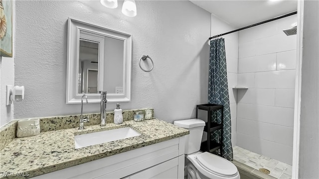 bathroom featuring vanity, curtained shower, and toilet