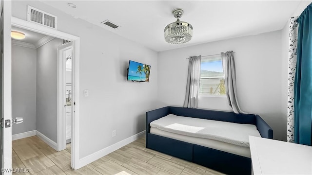 bedroom featuring crown molding and a chandelier