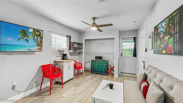 recreation room with ceiling fan and cooling unit