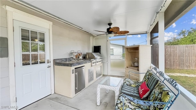 view of patio / terrace with an outdoor kitchen, a grill, and ceiling fan