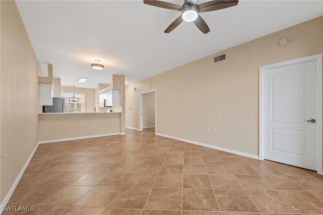 unfurnished living room with ceiling fan and light tile patterned flooring