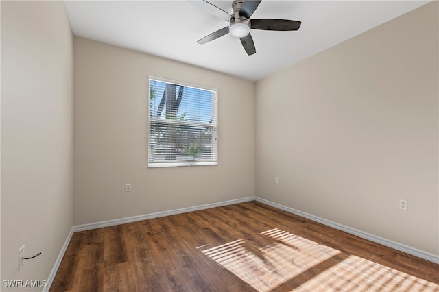 empty room with dark hardwood / wood-style flooring and ceiling fan