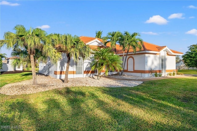 mediterranean / spanish house with a front yard