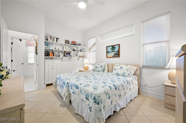 bedroom with ceiling fan and light tile patterned floors