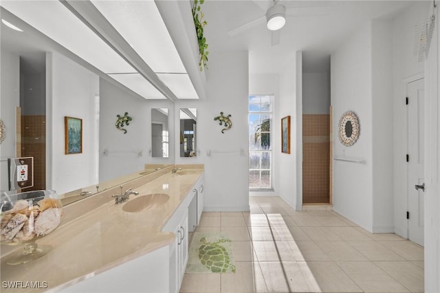 bathroom with tile patterned flooring, vanity, and ceiling fan