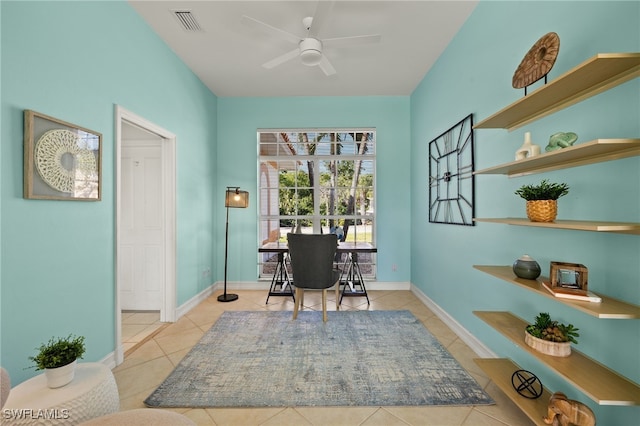 office space with tile patterned floors, a ceiling fan, visible vents, and baseboards