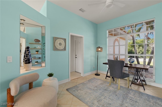 office space with tile patterned floors, visible vents, baseboards, and a ceiling fan