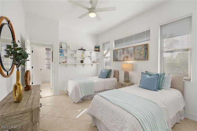 bedroom featuring baseboards, light tile patterned flooring, and a ceiling fan