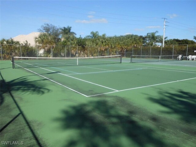 view of sport court featuring fence