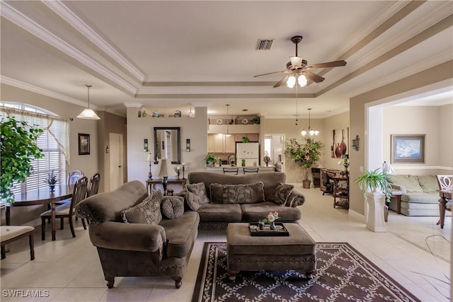 living room with a raised ceiling, crown molding, light tile patterned floors, and ceiling fan with notable chandelier