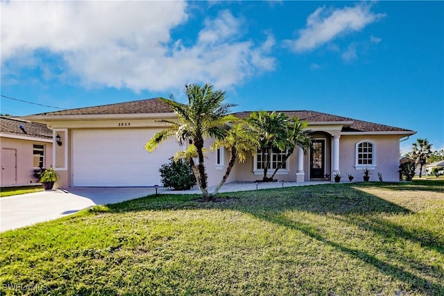 view of front of home featuring a front yard and a garage