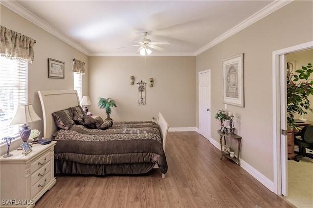 bedroom featuring multiple windows, ceiling fan, crown molding, and wood-type flooring