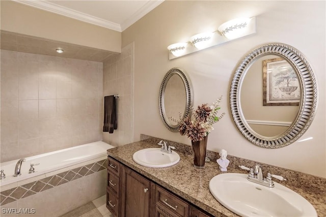 bathroom with vanity, tiled bath, and ornamental molding