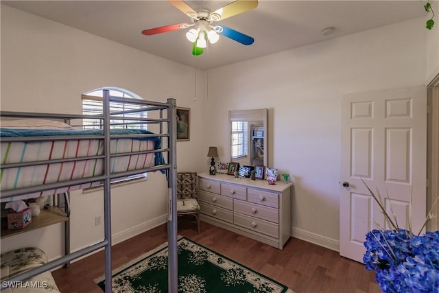 bedroom with ceiling fan and dark hardwood / wood-style flooring