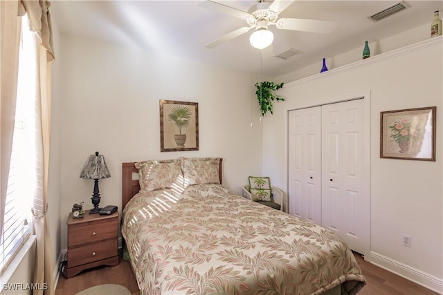 bedroom featuring hardwood / wood-style flooring, ceiling fan, and a closet