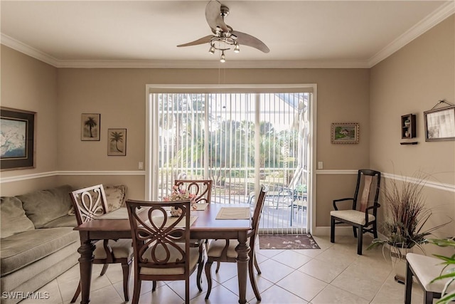 tiled dining room with ceiling fan and ornamental molding