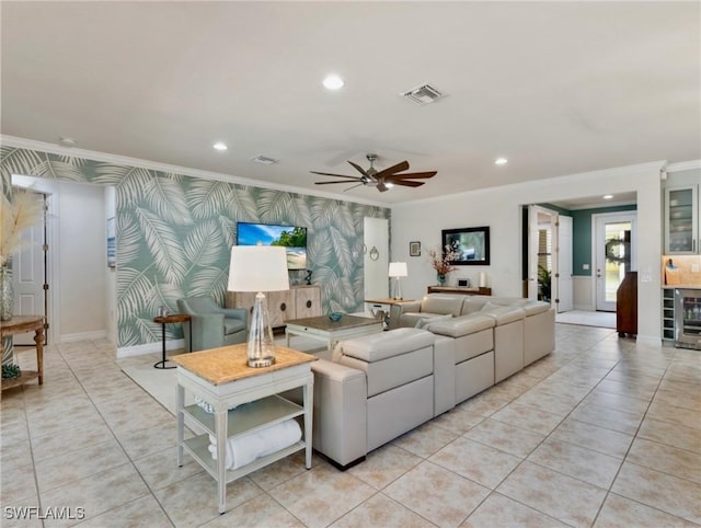 tiled living room featuring ceiling fan and ornamental molding