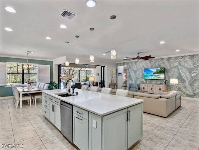 kitchen with ceiling fan, a kitchen island with sink, sink, decorative light fixtures, and dishwasher