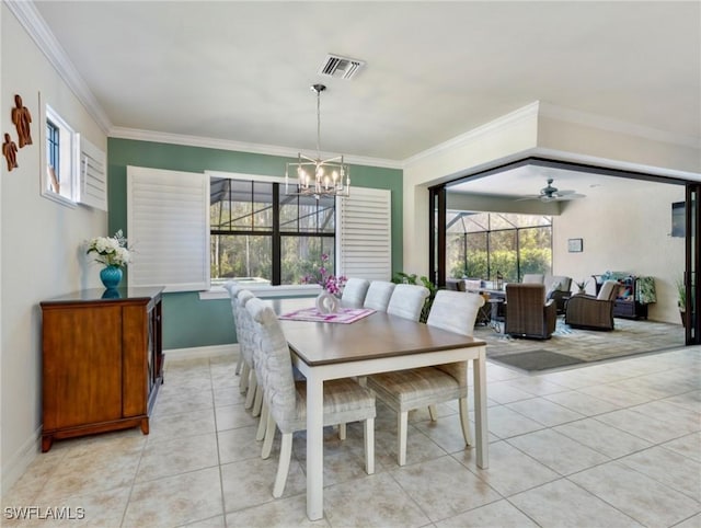 tiled dining area featuring a wealth of natural light, ceiling fan with notable chandelier, and ornamental molding